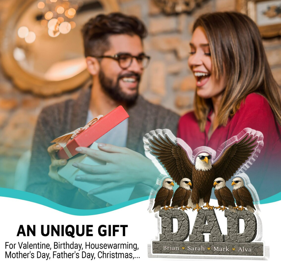 Man presenting a gift to a woman with an eagle statue labeled 'DAD' in the foreground.