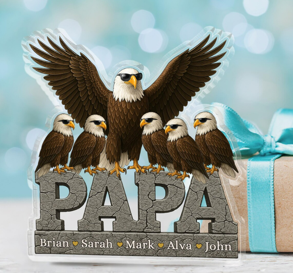 Decorative sign with eagles and 'PAPA' text on a blurred background