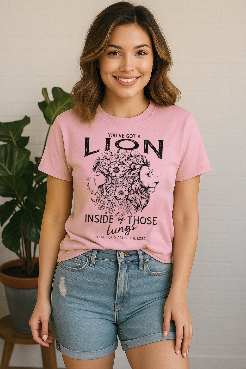 Blossom pink Comfort Colors shirt with lion-woman floral design and praise quote. Worn by smiling woman in summery vibe.
