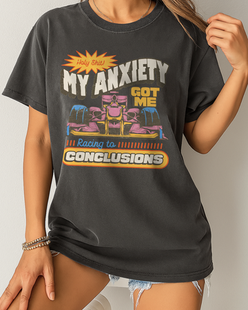 Black Comfort Colors shirt with a bold "My Anxiety Got Me Racing to Conclusions" design and colorful retro race car print