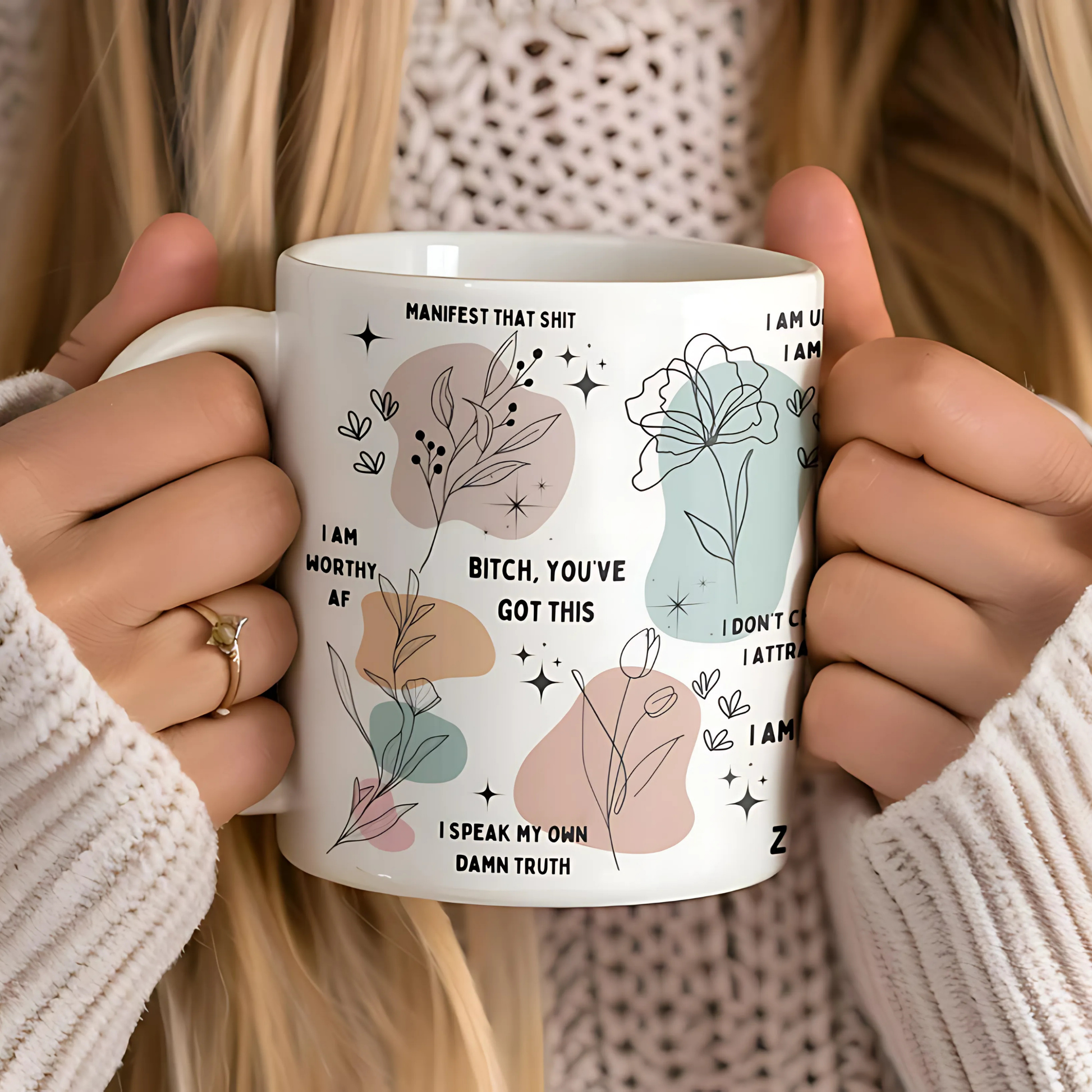 Woman holding a motivational coffee mug with colorful daily affirmations, cozy sweater aesthetic, empowering mental health vibe.

