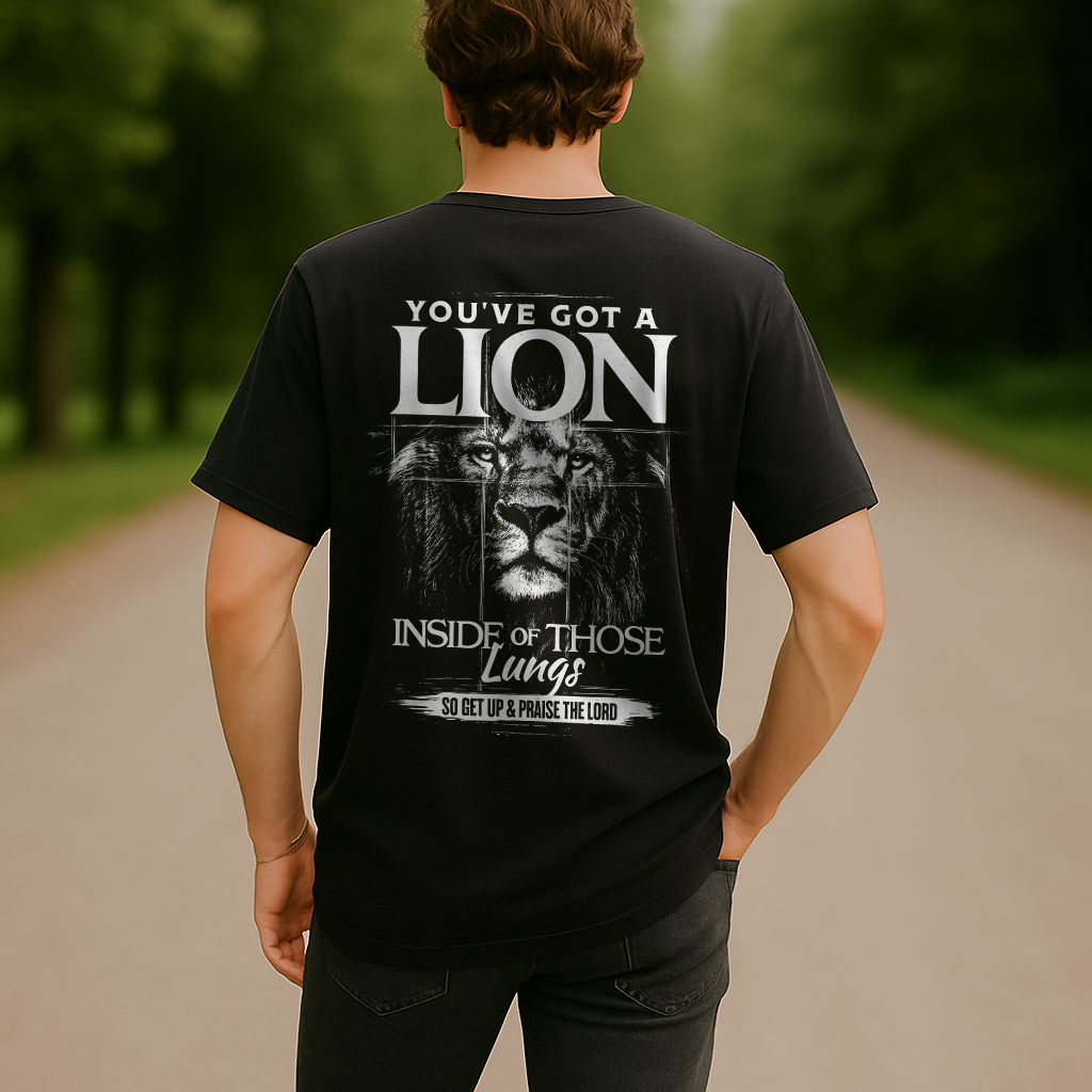Man wearing black “You’ve Got a Lion Inside Those Lungs” Christian shirt with bold lion graphic on the back