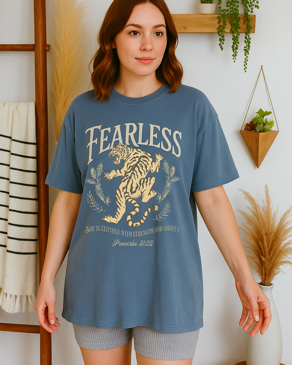 Blue Jean Comfort Colors t-shirt with tiger and Proverbs 31:25 verse “She is clothed with strength and dignity.” Modeled casually with light shorts.
