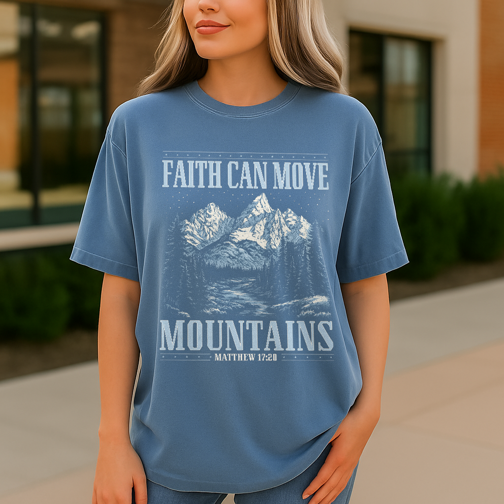 Woman in blue jean Comfort Colors tee with mountain and scripture print
