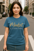 Blue Jean Comfort Colors shirt with motivational quote “Mindset Is Everything.” Styled with calm confidence on city street.
