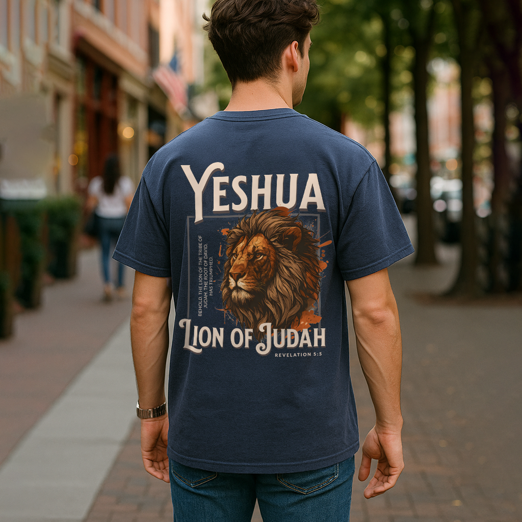 Man walking downtown in denim blue faith shirt featuring lion and "Yeshua" text design