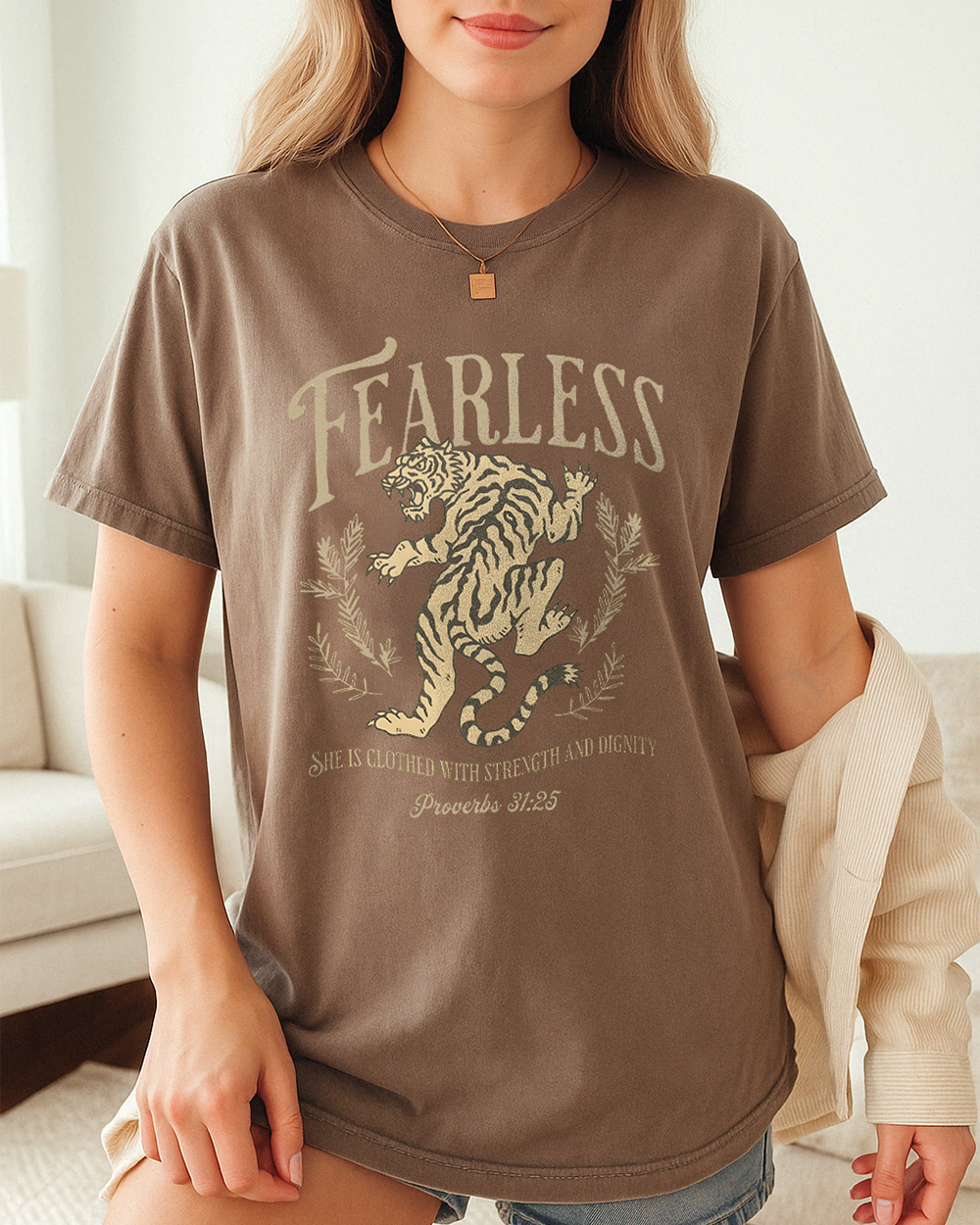 Espresso brown Comfort Colors tee with vintage tiger and Proverbs 31:25 faith quote. Styled in cozy indoor space.