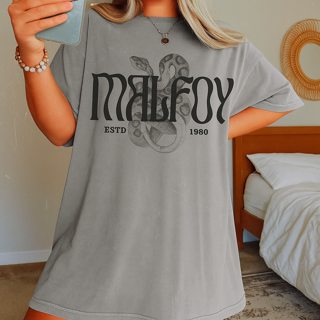 Girl taking a mirror selfie wearing grey Malfoy oversized tee