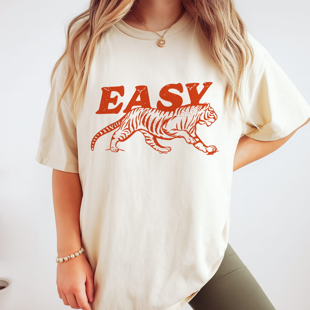 Man in ivory tiger graphic tee with “EASY” text, retro bold print