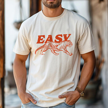 Man in ivory tiger graphic tee with “EASY” text, retro bold print