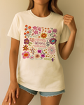 Relaxed summer look with ivory Comfort Colors tee and bright floral quote; worn by model standing confidently.