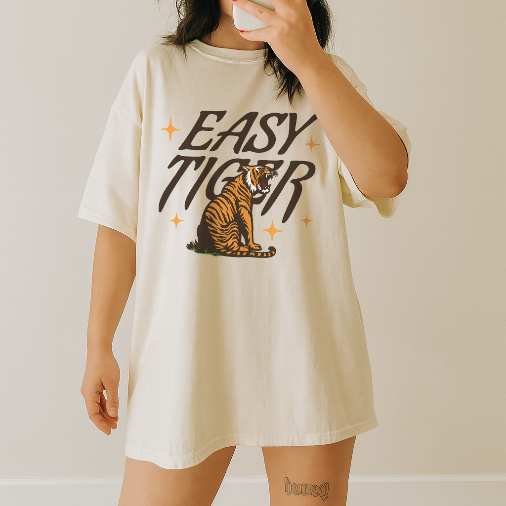 Woman wearing Easy Tiger graphic tee on ivory Comfort Colors oversized shirt – vintage aesthetic and relaxed fit