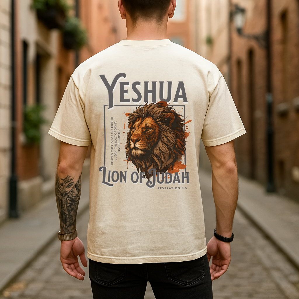 Man wearing black Yeshua Lion of Judah shirt with bold lion graphic and Bible verse on back, urban background