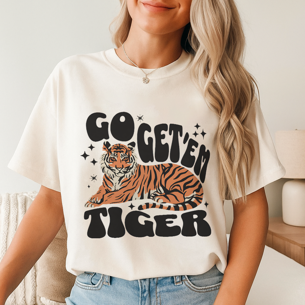 Ivory Go Get 'Em Tiger Comfort Colors tee – warm off-white base featuring bold tiger graphic and vintage lettering, styled in a bright neutral aesthetic.