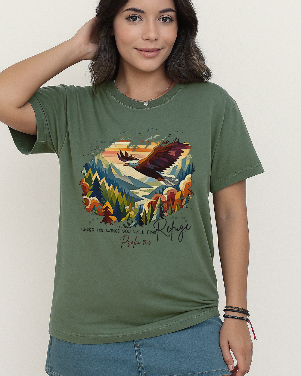 Moss green Comfort Colors tee with eagle soaring above multicolor landscape and Bible verse from Psalm 91:4.