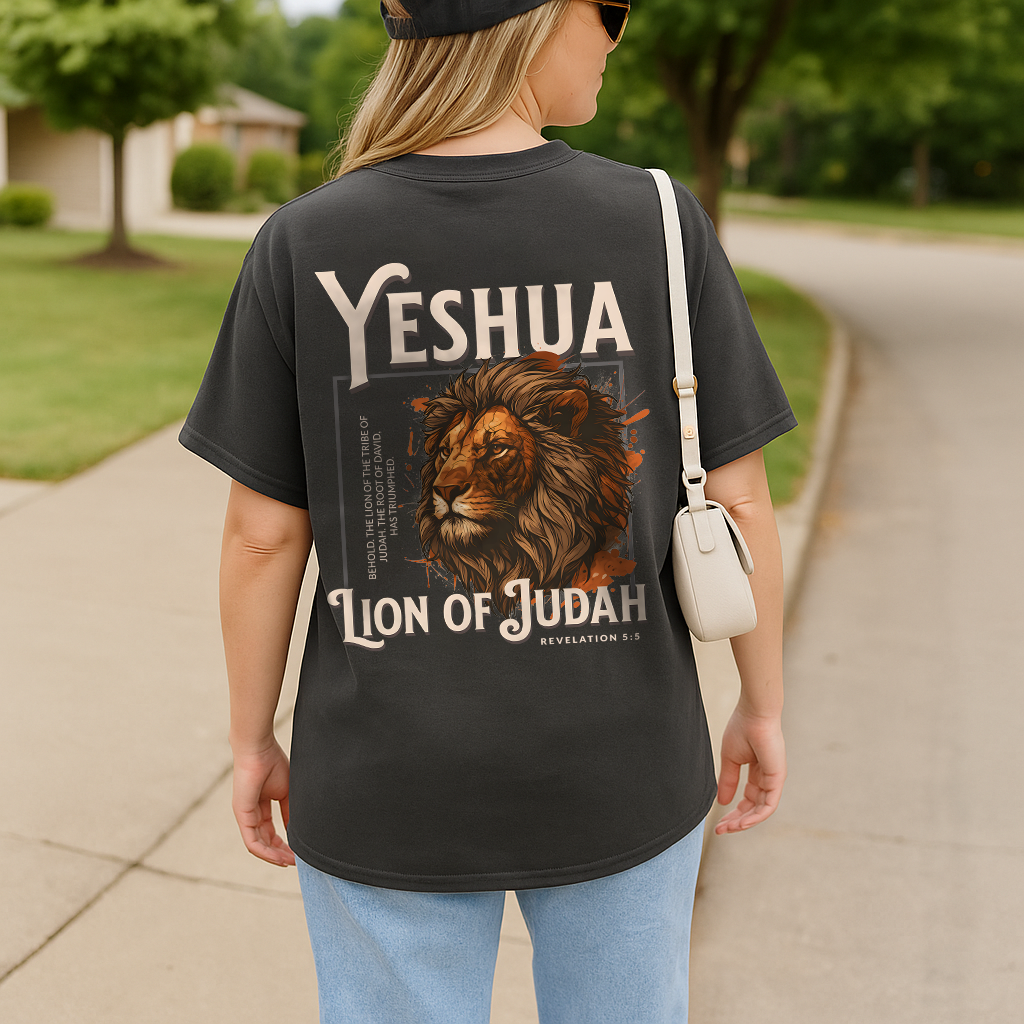 Woman in vintage pepper gray tee with faith-based lion design and bold "Yeshua" lettering