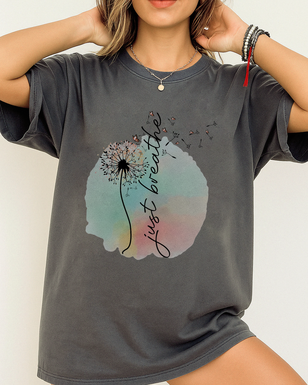 Pepper Comfort Colors 1717 shirt with dandelion “just breathe” quote and soft watercolor background.