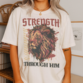 Close-up of woman wearing white Jesus Is King shirt with lion artwork and Bible-inspired text