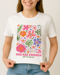 White Comfort Colors 1717 shirt with “You Are Enough” quote and colorful botanical art