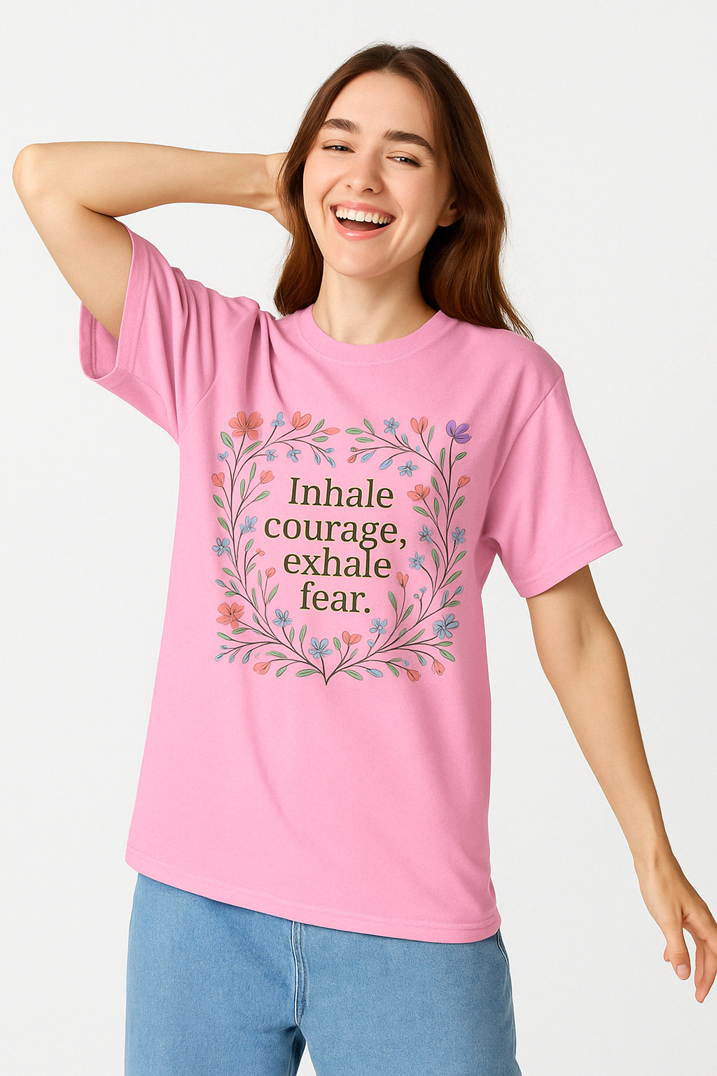 Blossom pink Comfort Colors 1717 t-shirt with floral “Inhale courage, exhale fear” design, worn by cheerful woman posing with one arm raised.
