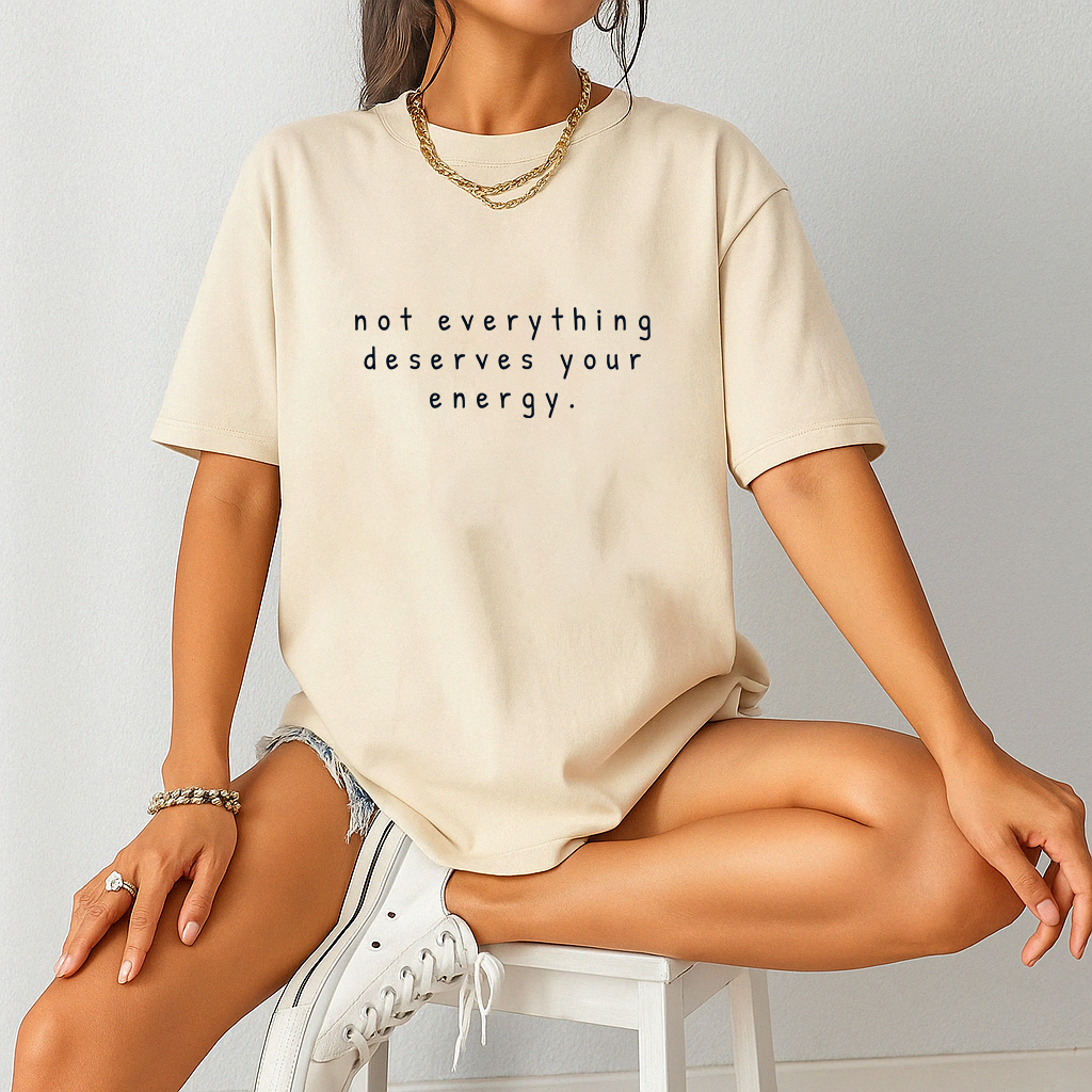 Comfort Colors mental health t-shirt – “not everything deserves your energy” quote tee worn by woman sitting indoors.