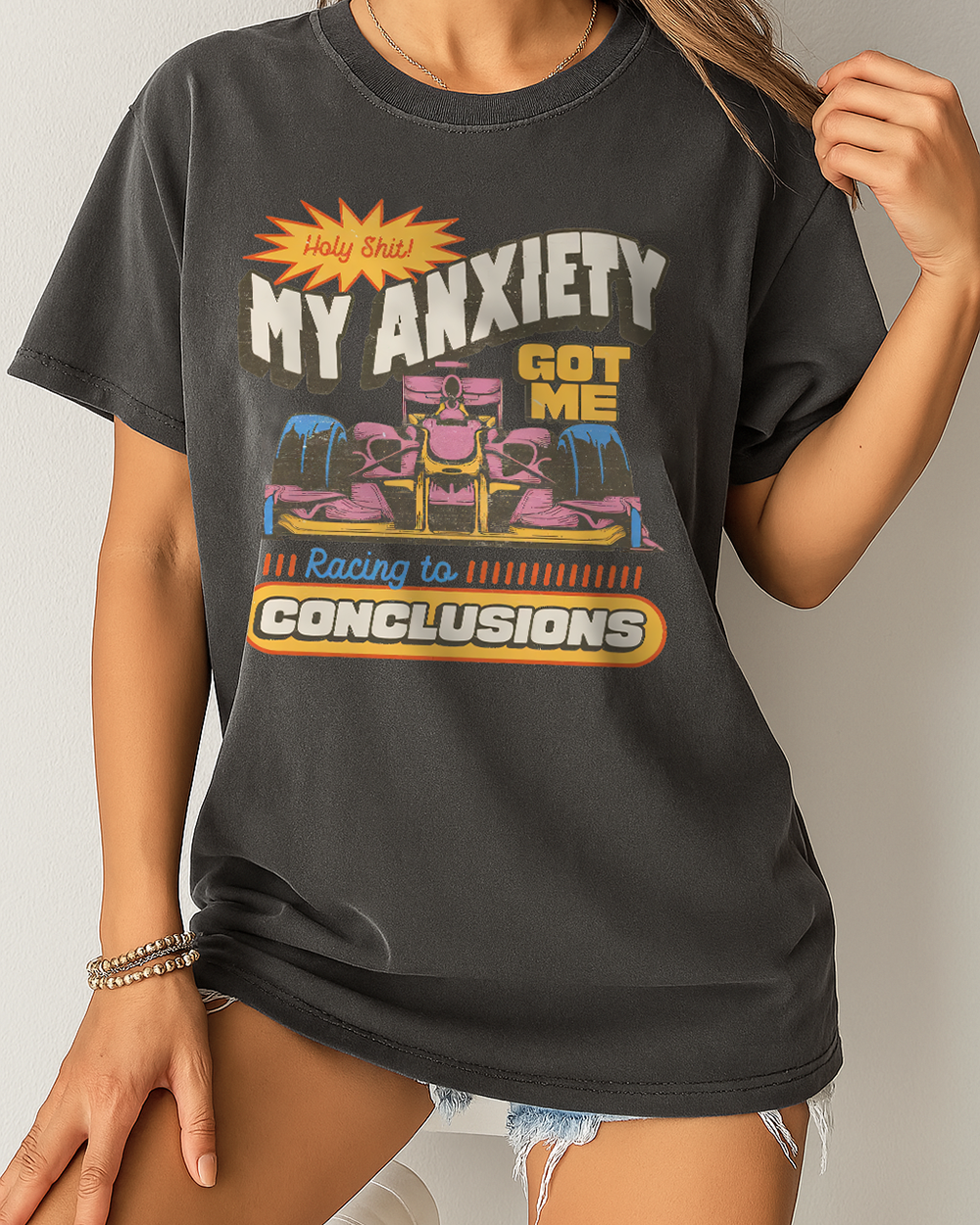 Black Comfort Colors shirt with a bold "My Anxiety Got Me Racing to Conclusions" design and colorful retro race car print
